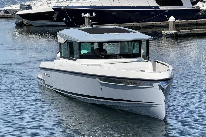 Slide: The Image of 2026 Saxdor 320 GTC boat docked in marina, sleek design, modern features. - 2