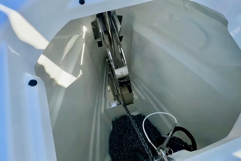 Slide: The Image of Anchor compartment of 2026 Saxdor 320 GTC boat, featuring chain and securing mechanism. - 21