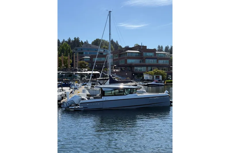 Slide: The Image of 2026 Saxdor 320 GTC boat docked in a marina with modern buildings in the background. - 22