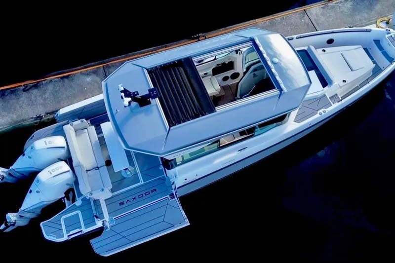 Slide: The Image of Aerial view of 2026 Saxdor 320 GTC boat docked, showcasing sleek design and dual engines. - 4
