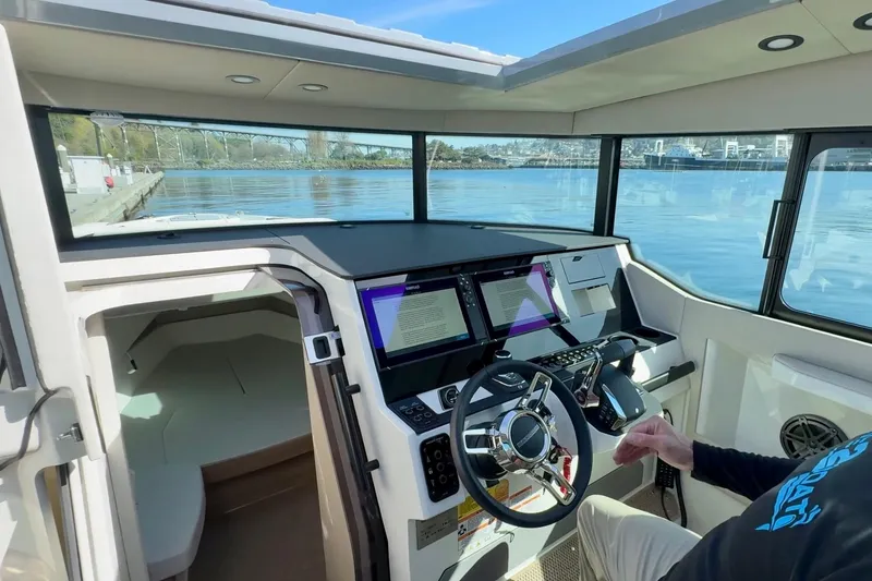 Slide: The Image of Interior view of 2026 Saxdor 320 GTC boat cockpit with modern controls and scenic water view. - 6