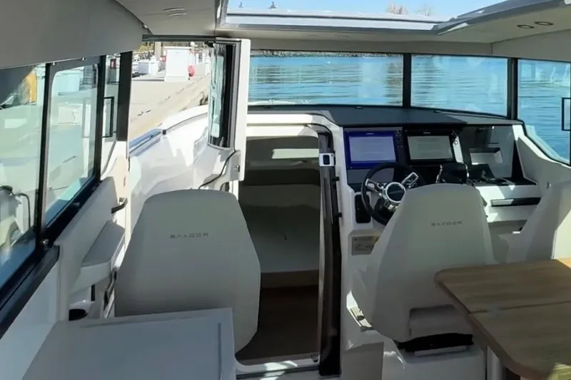 Slide: The Image of Interior of 2026 Saxdor 320 GTC boat with modern dashboard and seating. - 7