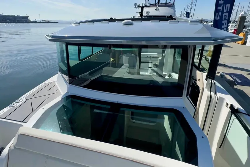 Slide: The Image of 2026 Saxdor 320 GTC boat docked, showcasing sleek design and modern glass cabin. - 8