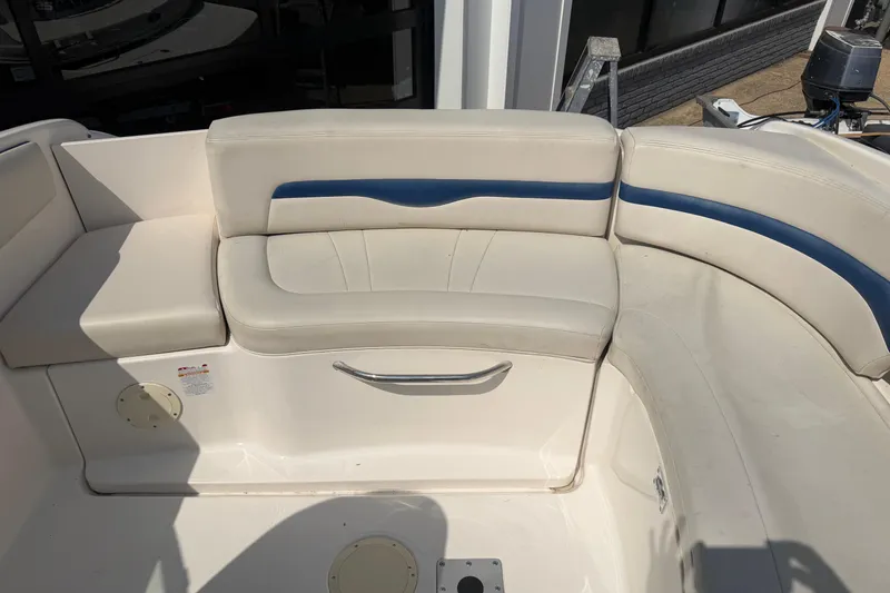 Slide: The Image of 2003 Chaparral 230 SSi boat interior with white and blue cushioned seating. - 10