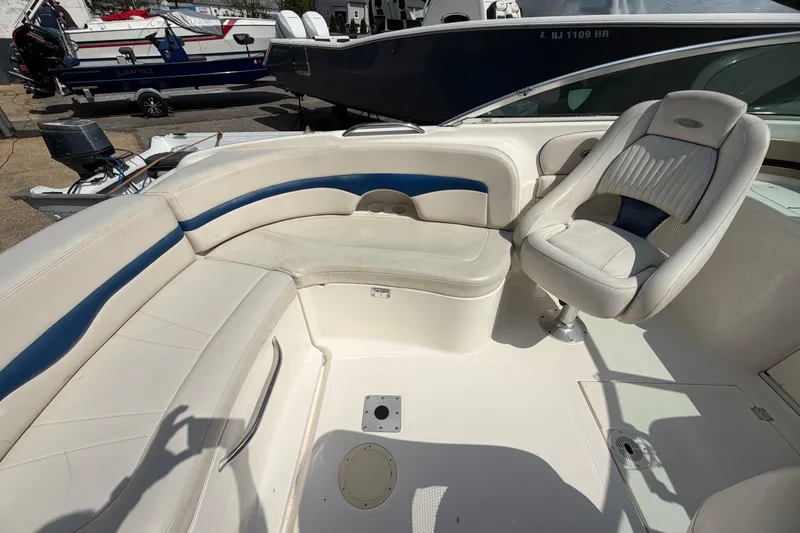 Slide: The Image of 2003 Chaparral 230 SSi boat interior with white and blue seating. - 12