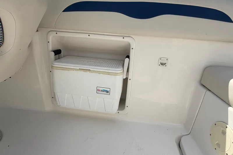 Slide: The Image of 2003 Chaparral 230 SSi boat interior with built-in cooler storage compartment. - 15