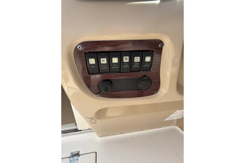 Slide: The Image of Control panel of a 2003 Chaparral 230 SSi boat with switches and outlets. - 16