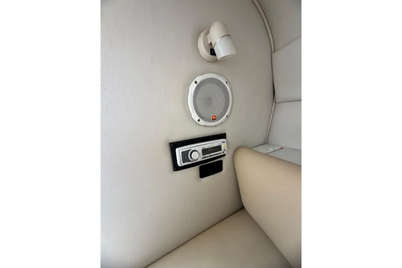 Slide: The Image of Interior of 2003 Chaparral 230 SSi boat with speaker and control panel. - 21