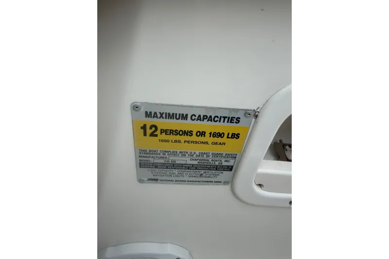 Slide: The Image of 2003 Chaparral 230 SSi capacity plate, maximum 12 persons or 1690 lbs. - 27