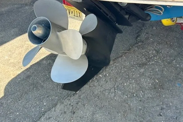 Slide: The Image of 2003 Chaparral 230 SSi boat on trailer, parked outdoors near a building. - 4