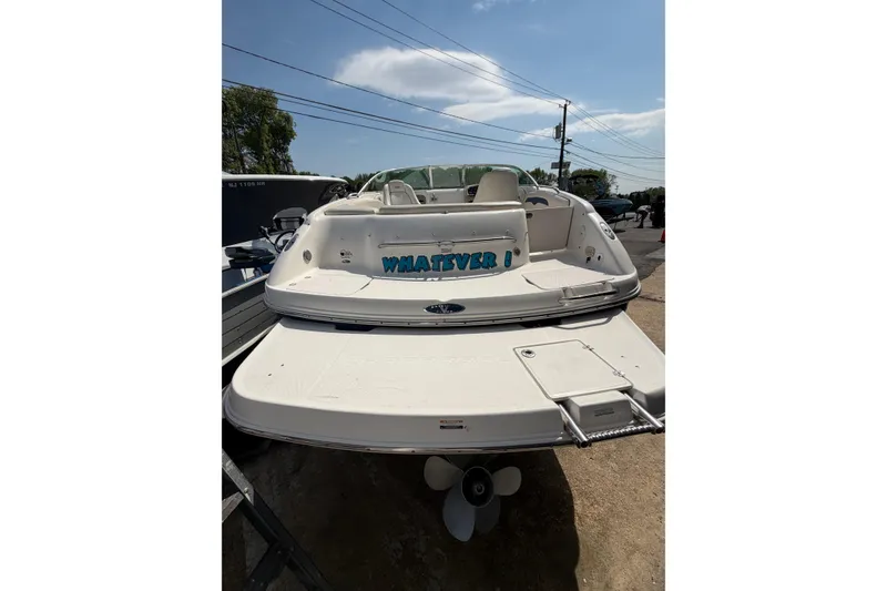 Slide: The Image of 2003 Chaparral 230 SSi boat with swim platform and ladder, docked outdoors. - 8
