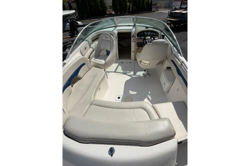 Slide: The Image of 2003 Chaparral 230 SSi boat interior with white seating and steering console. - 9