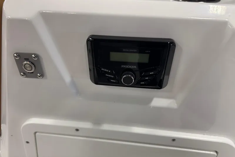 Slide: The Image of Control panel of a 2025 Tahoe 1950 boat featuring a Kicker media center. - 11