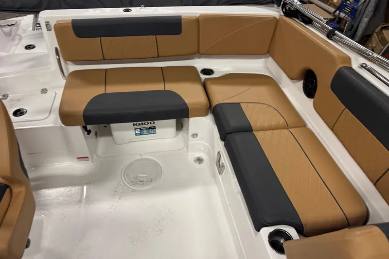 Slide: The Image of 2025 Tahoe 1950 boat interior with tan and black seating, featuring an Igloo cooler. - 12