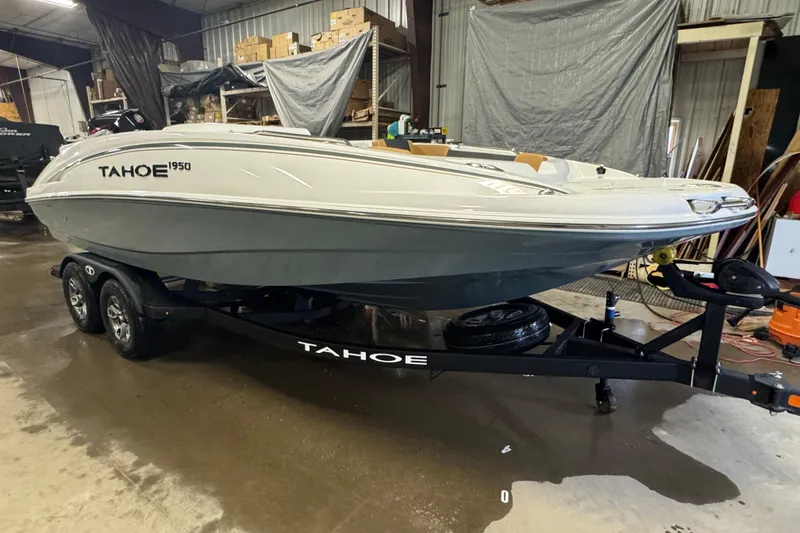 Slide: The Image of 2025 Tahoe 1950 boat on trailer in indoor storage facility. - 2