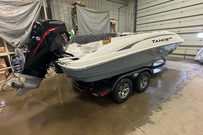 Slide: The Image of 2025 Tahoe 1950 boat in garage, featuring sleek design and powerful outboard motor. - 3
