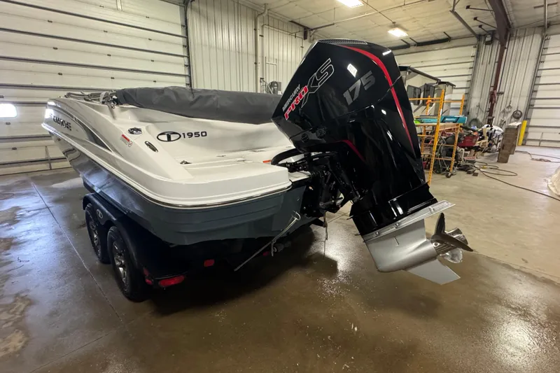 Slide: The Image of 2025 Tahoe 1950 boat with Mercury Pro XS 175 engine in a garage setting. - 4