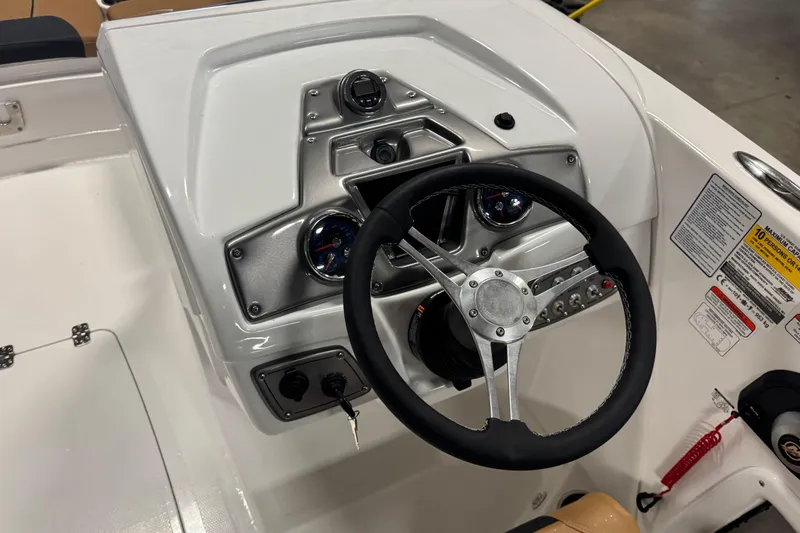 Slide: The Image of Steering console of a 2025 Tahoe 1950 boat with gauges and controls. - 6