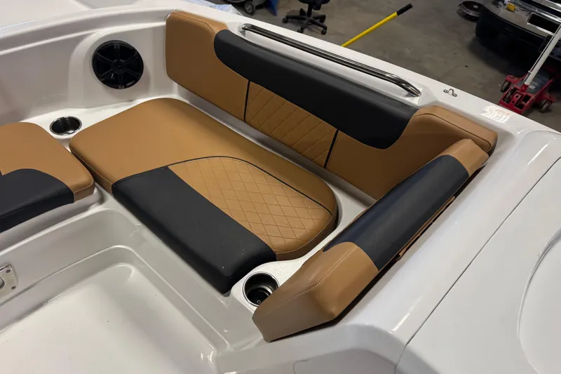 Slide: The Image of 2025 Tahoe 1950 boat interior with tan and black cushioned seating. - 9