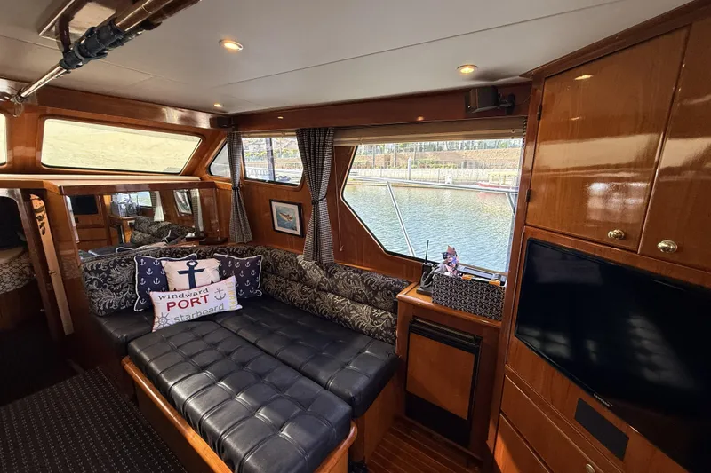 Slide: The Image of Luxurious interior of a 2003 Mikelson Sportfisher yacht with elegant wood finishes. - 10