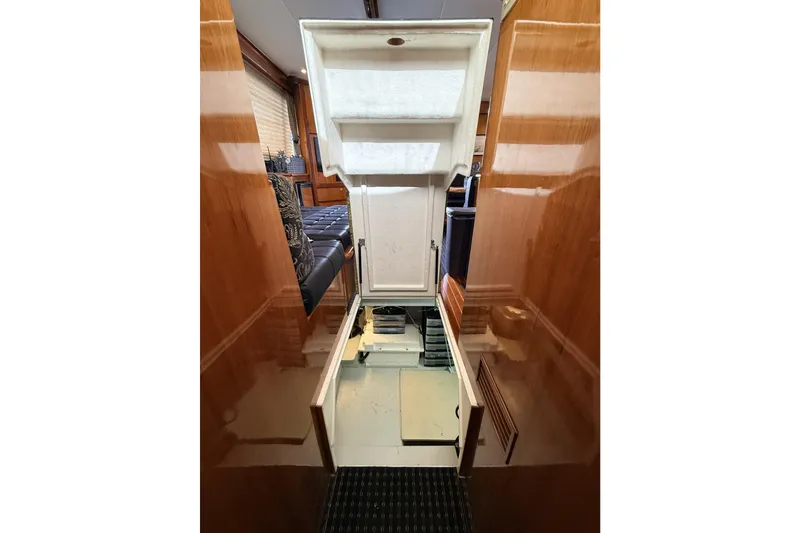 Slide: The Image of 2003 Mikelson Sportfisher interior with open hatch, showcasing sleek wooden finishes. - 12