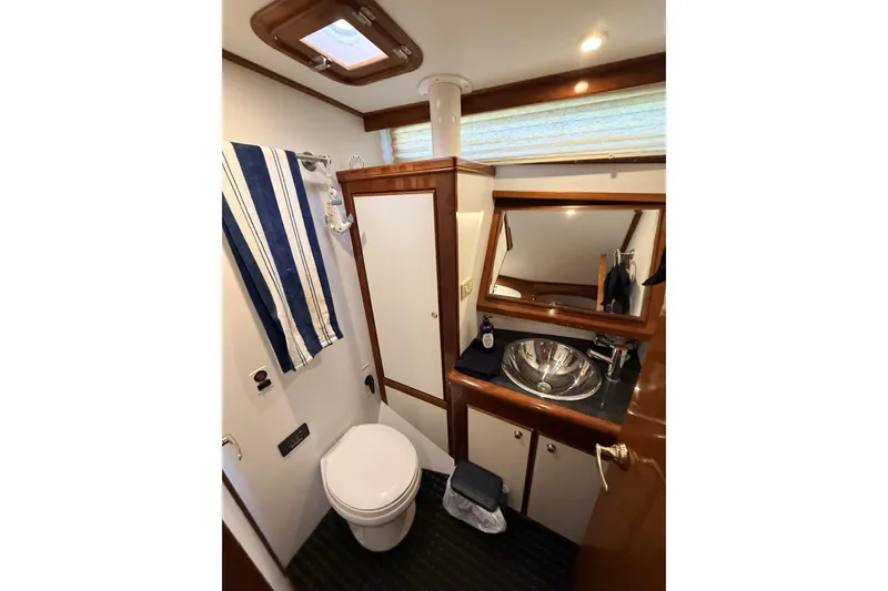 Slide: The Image of Bathroom interior of 2003 Mikelson Sportfisher yacht with sink, toilet, and mirror. - 17