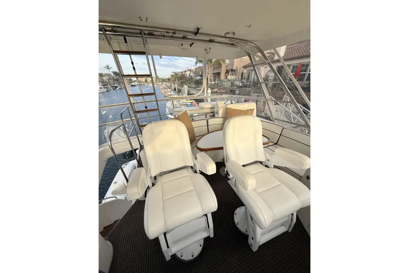 Slide: The Image of Luxurious 2003 Mikelson Sportfisher yacht interior with plush white seating and waterfront view. - 22