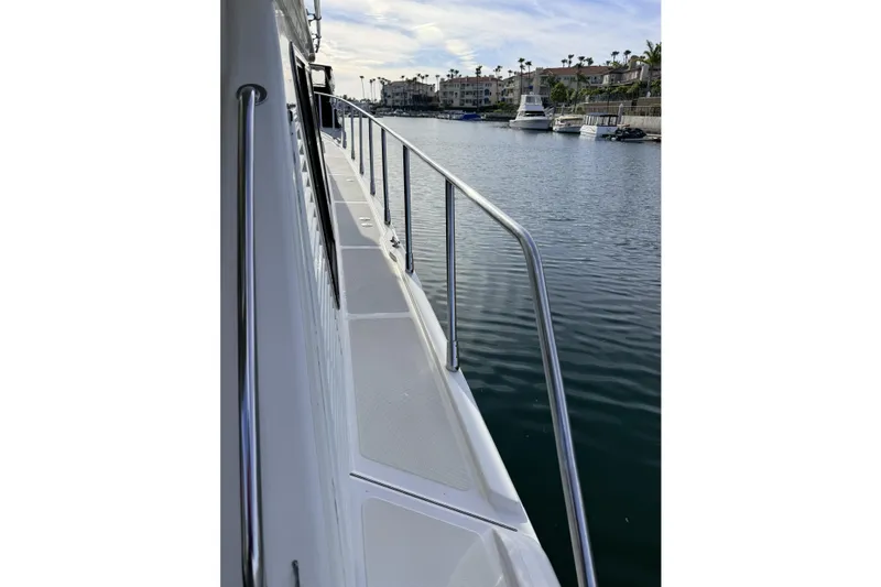 Slide: The Image of Side view of a 2003 Mikelson Sportfisher yacht docked in a marina. - 24