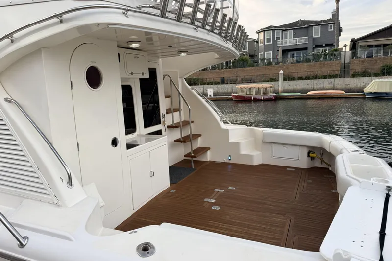 Slide: The Image of 2003 Mikelson Sportfisher yacht with spacious deck and elegant wooden flooring. - 3