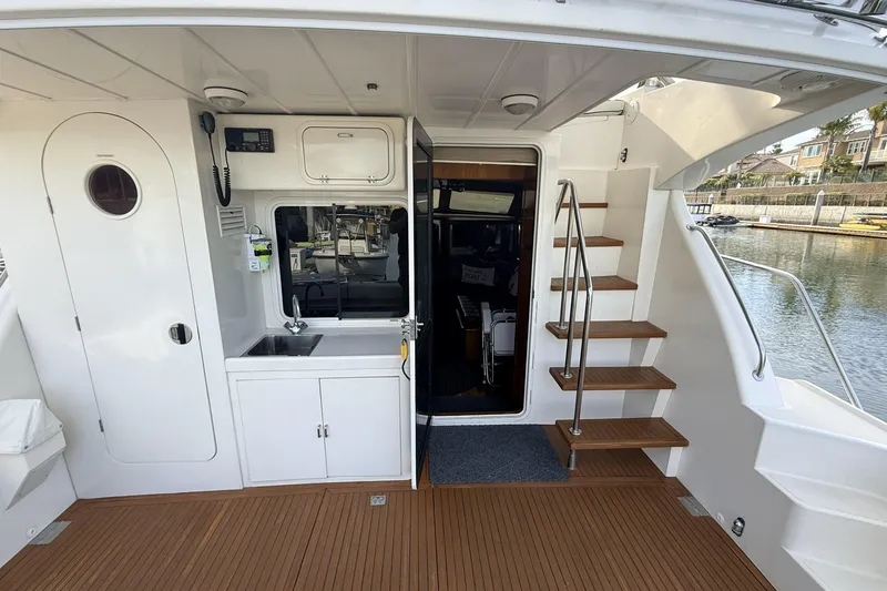 Slide: The Image of 2003 Mikelson Sportfisher yacht interior with stairs, sink, and door to cabin. - 4