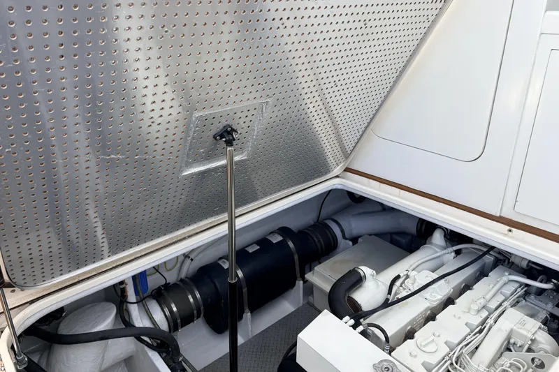 Slide: The Image of Engine compartment of a 2003 Mikelson Sportfisher boat, showcasing mechanical components and insulation. - 6