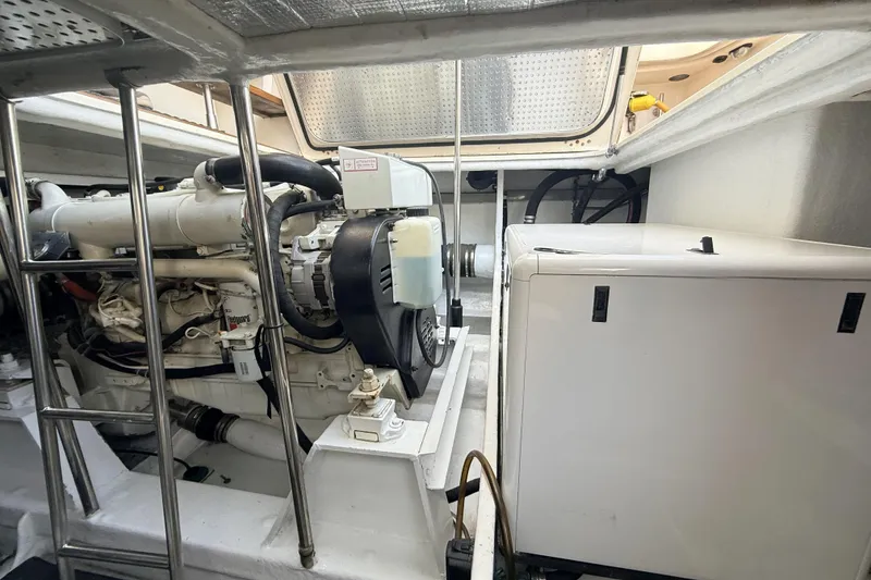 Slide: The Image of Engine room of a 2003 Mikelson Sportfisher boat, showcasing machinery and equipment. - 7