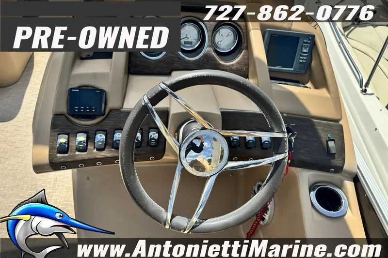 Slide: The Image of Pre-owned 2016 Bennington 2550 RS boat dashboard with steering wheel and controls. - 12