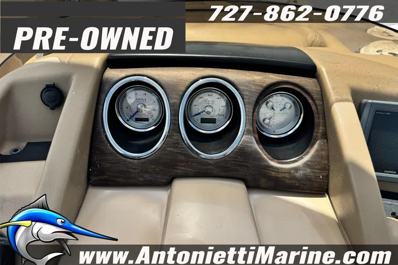 Slide: The Image of Dashboard of a 2016 Bennington 2550 RS boat, featuring gauges and pre-owned label. - 13
