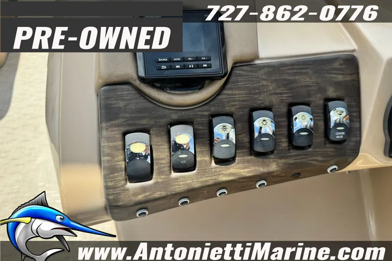Slide: The Image of Control panel of a pre-owned 2016 Bennington 2550 RS boat, featuring switches and a display. - 16