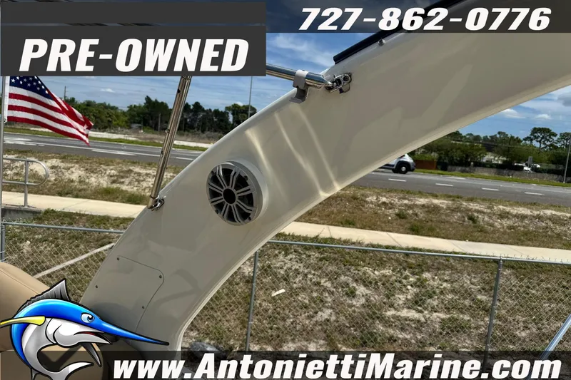Slide: The Image of Pre-owned 2016 Bennington 2550 RS boat with speaker, American flag, and contact details. - 22