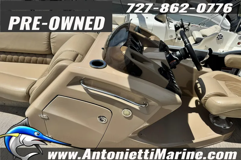 Slide: The Image of Pre-owned 2016 Bennington 2550 RS boat interior with tan seating and steering console. - 9