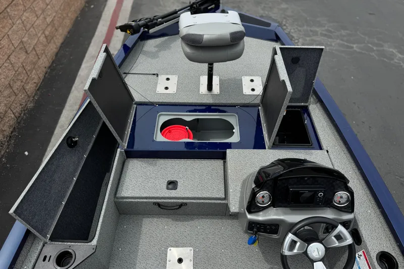 Slide: The Image of 2024 G3 Sportsman 1710 boat interior with storage compartments and steering console. - 13