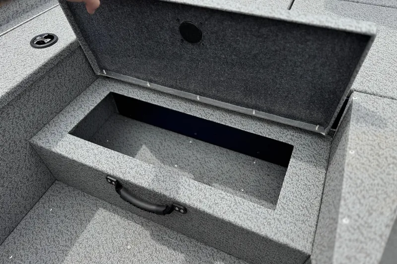 Slide: The Image of Open storage compartment on 2024 G3 Sportsman 1710 boat, featuring a textured interior. - 14