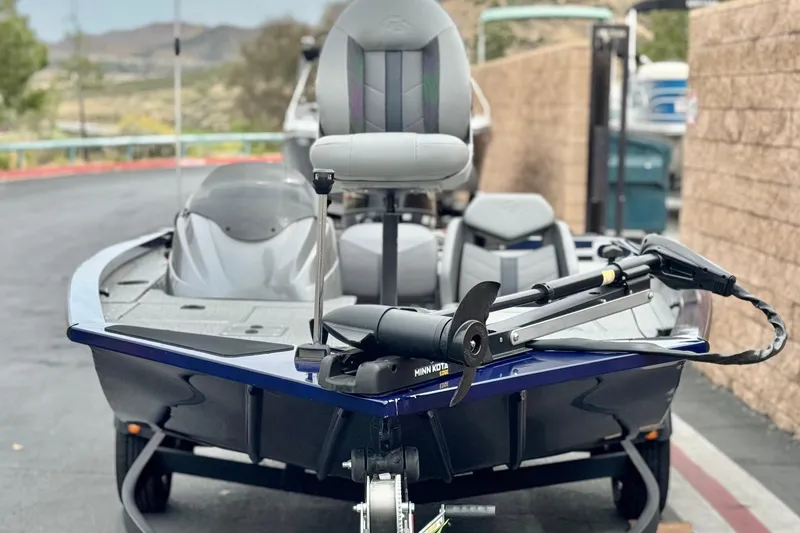 Slide: The Image of 2024 G3 Sportsman 1710 boat with Minn Kota trolling motor, parked outdoors. - 2