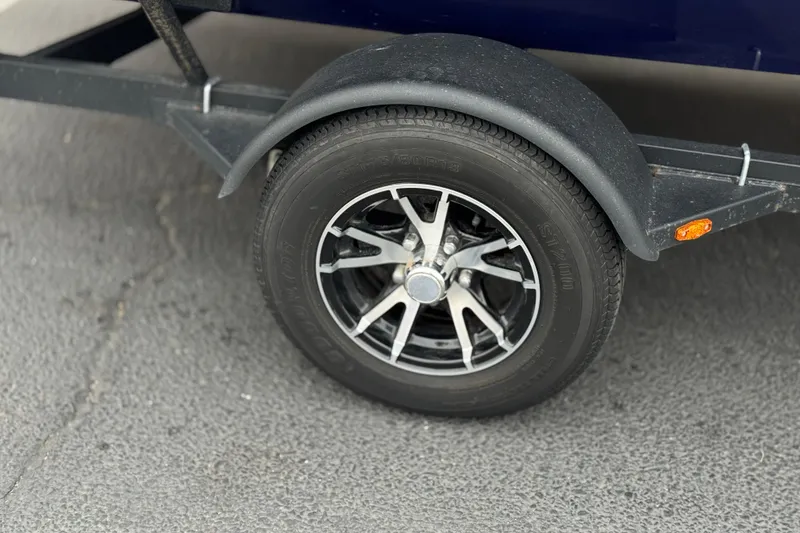 Slide: The Image of Trailer wheel of 2024 G3 Sportsman 1710, featuring black alloy rim and tire. - 20