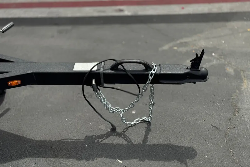 Slide: The Image of Trailer hitch of 2024 G3 Sportsman 1710 with safety chains on asphalt. - 21