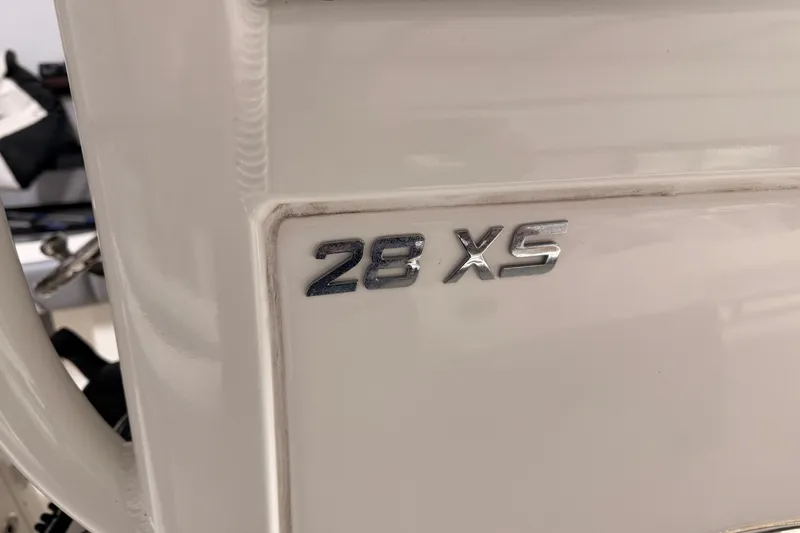 Slide: The Image of 2021 NauticStar 28 XS boat emblem on white surface. - 12
