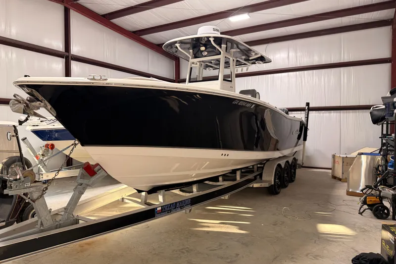 Slide: The Image of 2021 NauticStar 28 XS boat on trailer in indoor storage facility. - 4