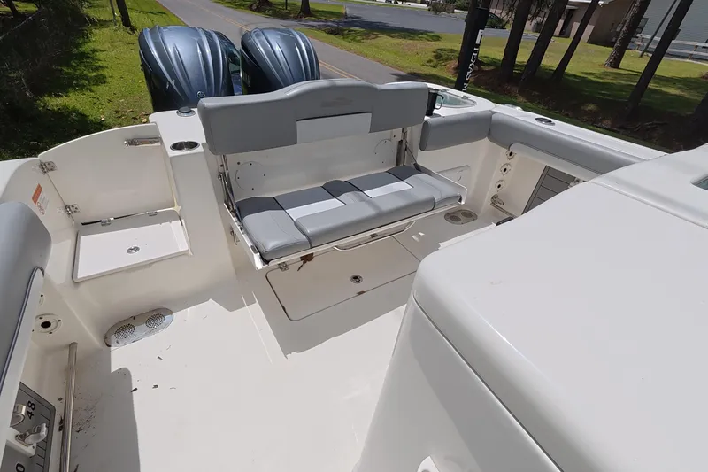 Slide: The Image of 2021 NauticStar 28 XS boat interior with seating and twin engines. - 7