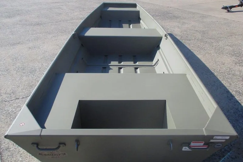 Slide: The Image of 2026 Tracker Grizzly 14 Jon boat, empty interior view on concrete surface. - 3