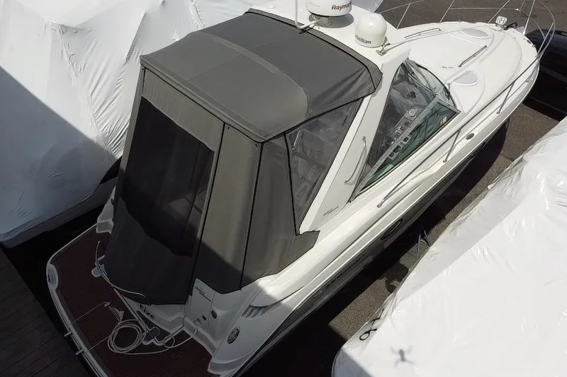 The Image of 2009 Monterey 320 Sport Yacht docked at marina under clear blue sky. - 0