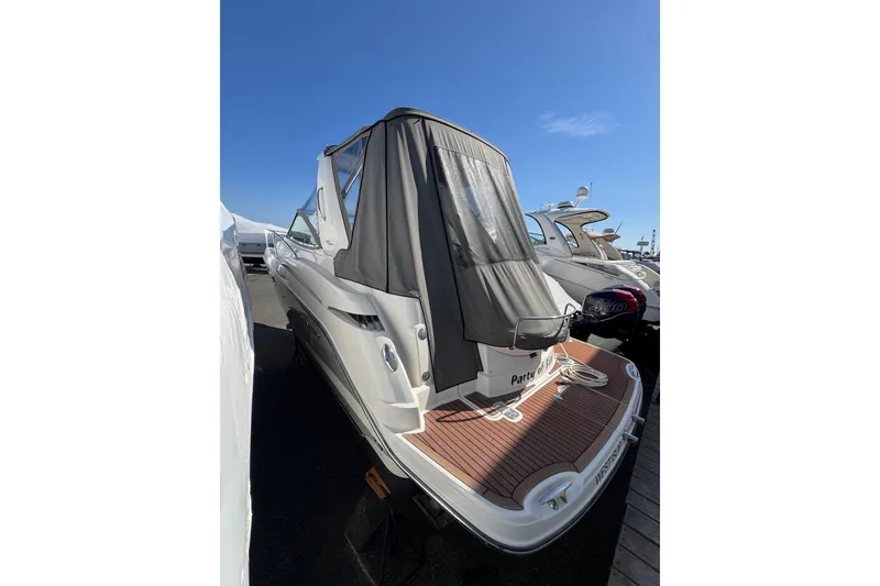 Slide: The Image of 2009 Monterey 320 Sport Yacht docked, featuring covered deck and sleek design. - 12