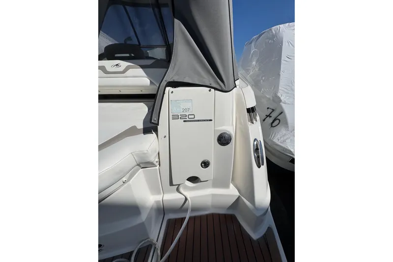 Slide: The Image of 2009 Monterey 320 Sport Yacht stern storage with fenders and ropes, labeled "Party of Five." - 17