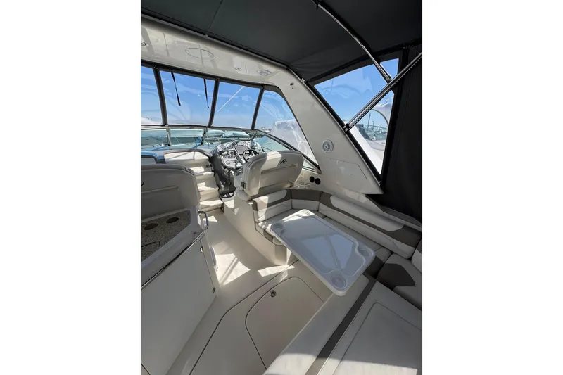 Slide: The Image of White leather seating in a 2009 Monterey 320 Sport Yacht cockpit area. - 23